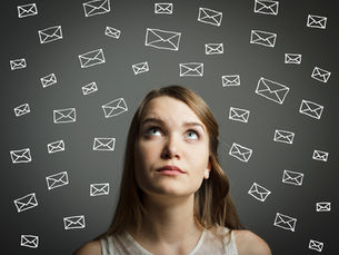 Image of woman with pondering expression surrounded by email message icons