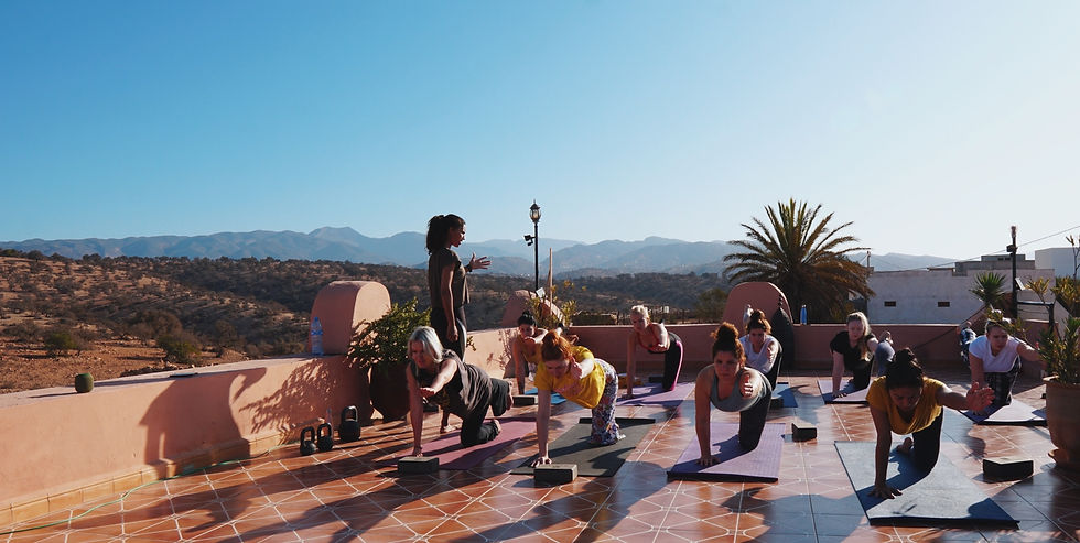 Teacher and yogi guests doing a yoga session our our Tamraght surf house