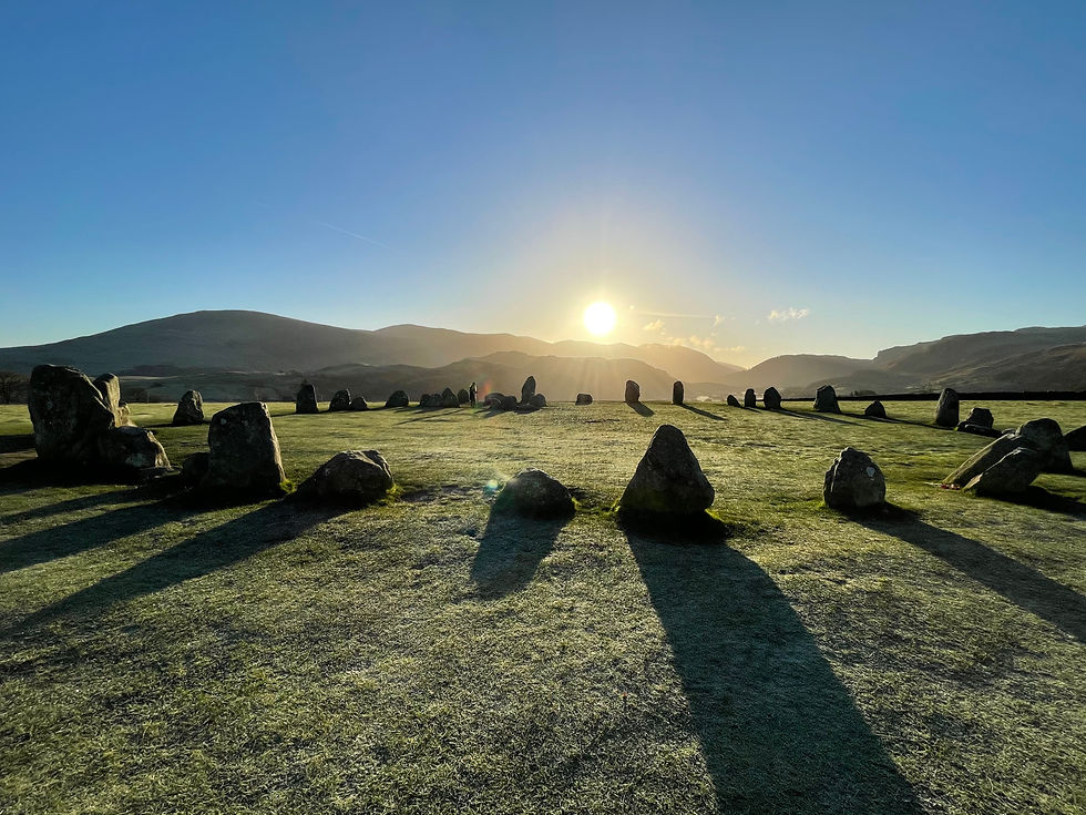 The winter sun low in the sky overlooking castlerigg stone circle