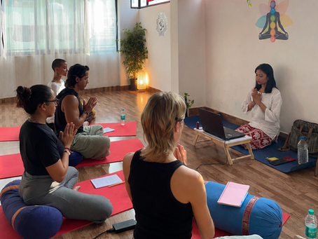 Reiki Master teaching students during a Reiki training class at AARAK – School of Sacred Healing Arts in Rishikesh.