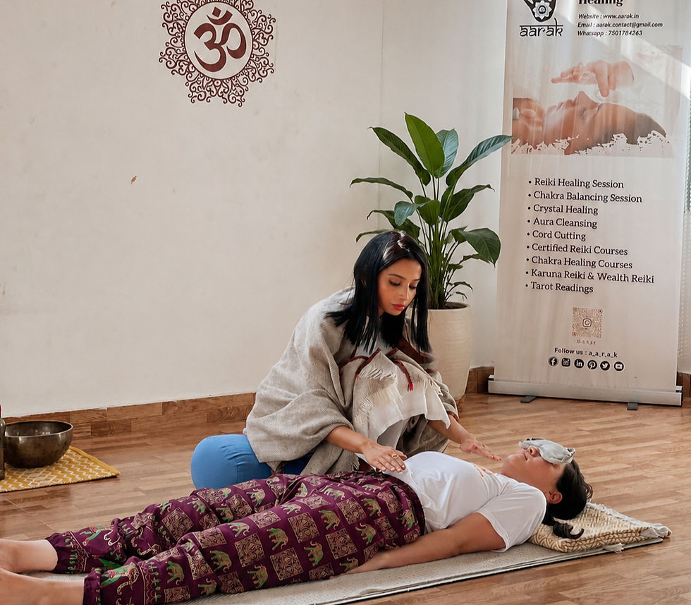 Reiki Grandmaster Sanghamitra channeling healing energy during a hands-on Usui Reiki session on a client at Aarak School of Sacred Healing Arts in Rishikesh.
