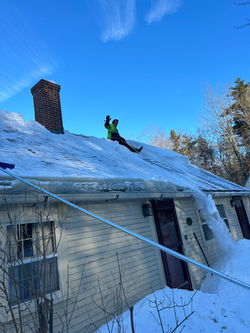 snow removal services on a residential roof