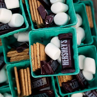 Individual s’mores kits displayed in teal cartons, each filled with mini Hershey’s chocolate bars, marshmallows, and graham crackers, ready for a fun fall or campfire event.