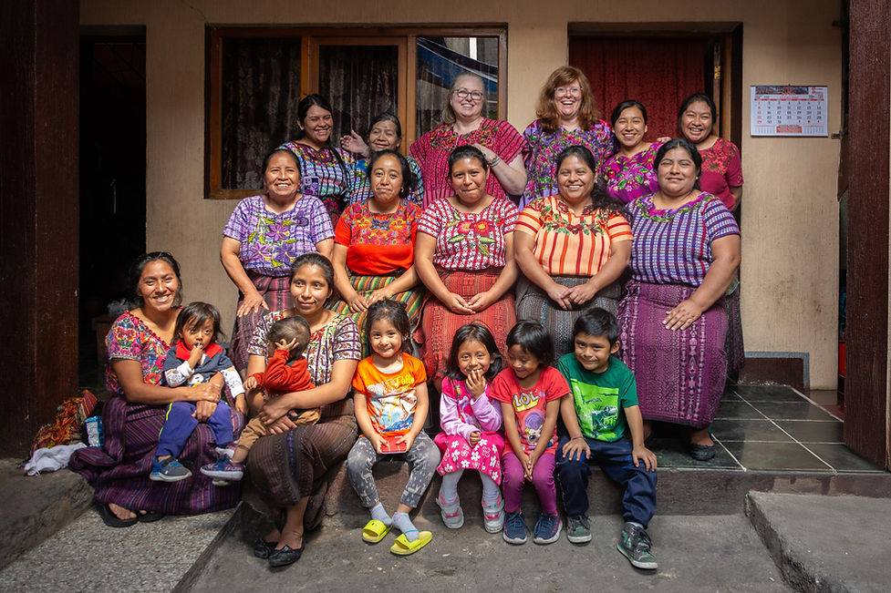 A group of Mayan artesans wearing traditional Mayan clothes with bright patterns