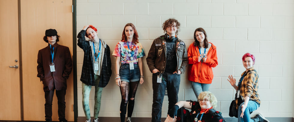 A group of seven adolescents posing and smiling for the camera.