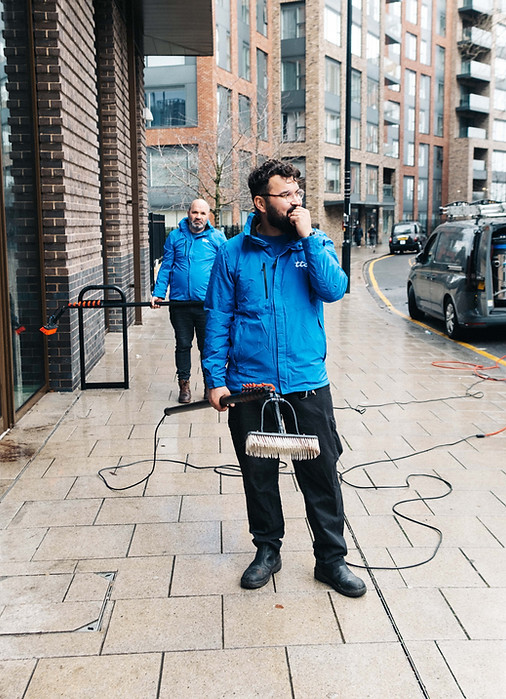 staff members holding window cleaning equipment