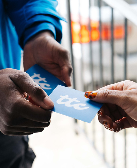 staff member passing a business card to a customer