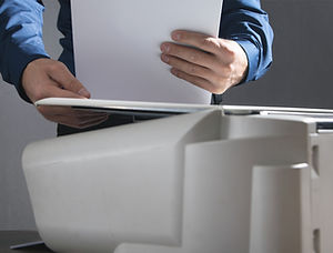 Paper documents being scanned and digitized with OCR technology for easy access and management.