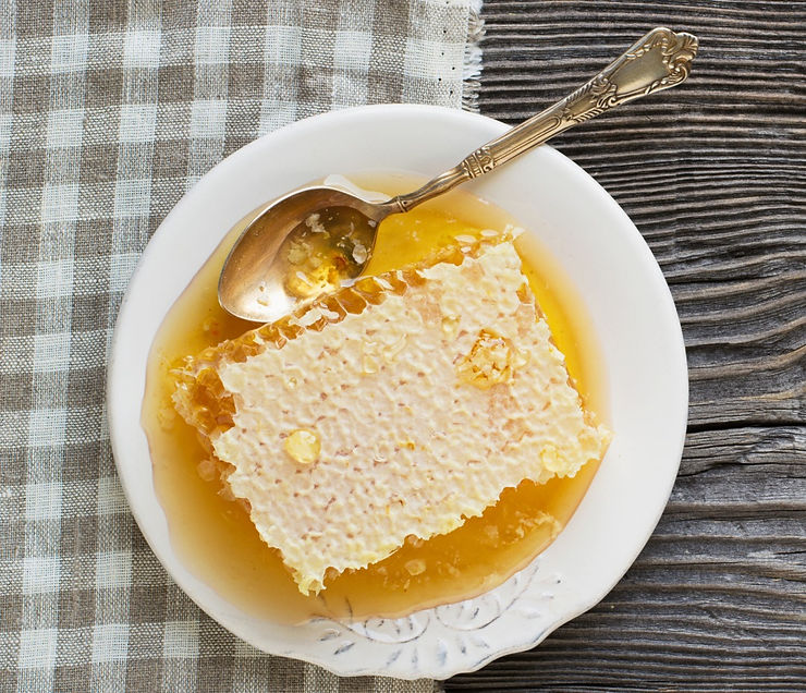 Enjoy honeycomb by the spoonful - piece of raw honeycomb in a dish with spoon