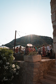 Guests enjoy an outdoor wedding breakfast at dusk