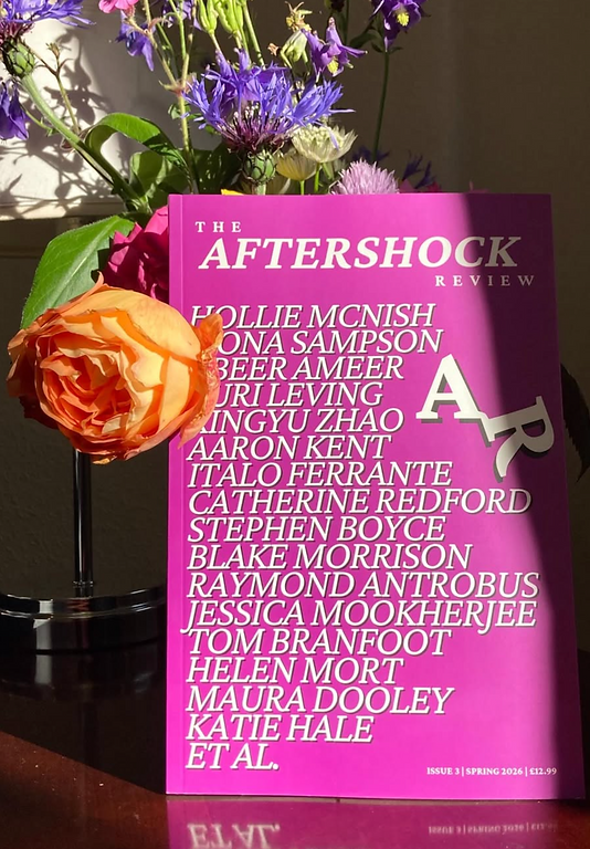 a photo of issue three next to some roses