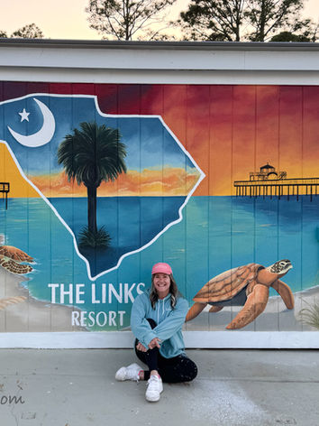 Exterior mural at The Links Resort in North Myrtle Beach featuring the South Carolina state outline, sea turtlem coastal sunset, and resort branding by mural artist Michelle Ricalde