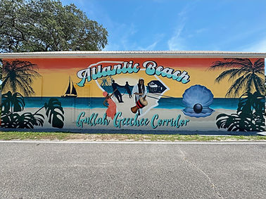 Atlantic Beach Gullah Geechee Corridor mural by Jersey Girl Art featuring coastal South Carolina imagery, ocean views, palm trees, cultural heritage elements, and public art celebrating the history of Atlantic Beach, SC.