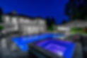 The backyard of a mansion showing a hot tub and a pool