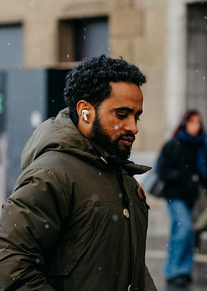 Man walking in a city with AirPods in his ears