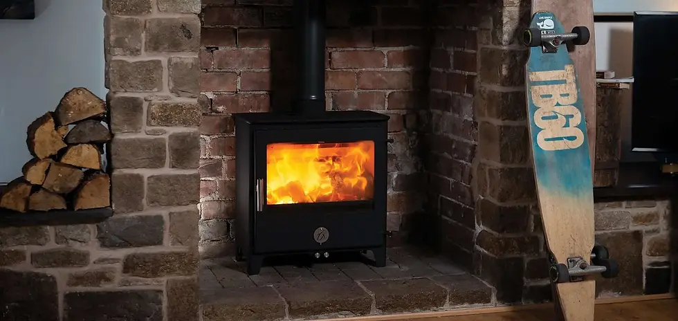 A burning Chilli Penguin Woody CAT wood burning stove in a brick fireplace