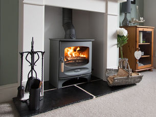 Charnwood C-Five woodburning stove in fireplace in light airy room