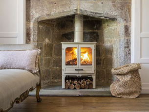 A rustic wood burning stove adds warmth and charm to a cozy living area.
