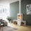 Thumbnail: Lit Rais Nexo 120 Woodburning stove in sand with log stores to the side. A beige rug and couch compliment.