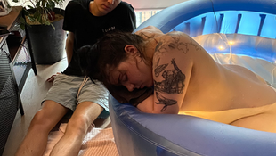 Husband watching and supporting wife birth at home