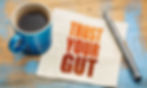 Trust your gut image with coffee and a pen