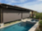 Retractable patio shades installed over a poolside lounge area.