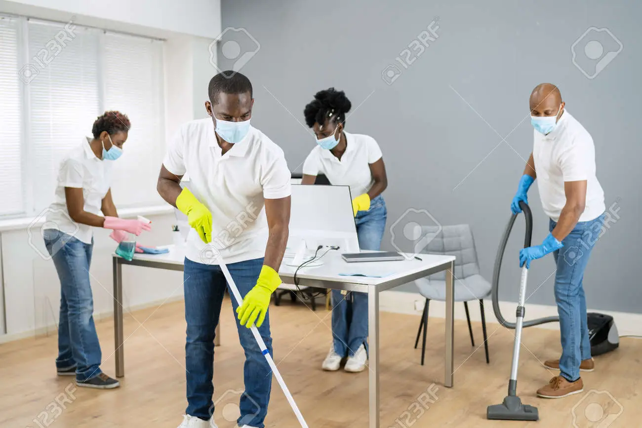 166723580-cleaning-service-african-janitor-in-face-mask.webp