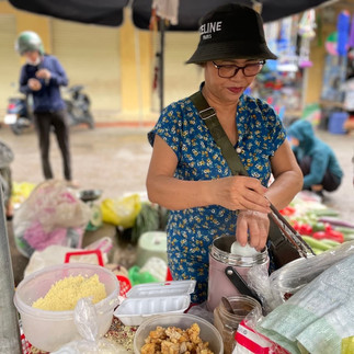 Selling breakfast at a local market in Dong Hoi