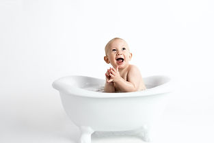 baby-laughing-in-bathtub-placed-in-white-background.jpg