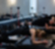 Row of people in plank position on megaformer