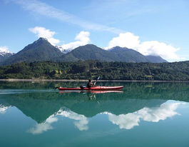 Kayak Puerto Varas Sea kayak on Reloncaví Fjord, town of Cochamó. Views to Rollizo Peninsula, chilean Patagonia.