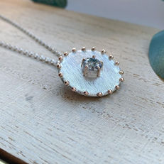 Textured rose gold and silver pendant.