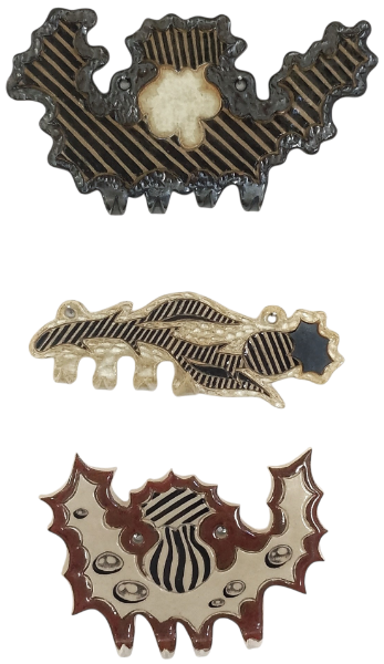 Three ceramic jewellery hooks with thistles and raindrops