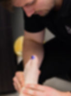 A doctor carefully assesses foot pain to develop a tailored treatment plan for effective care.