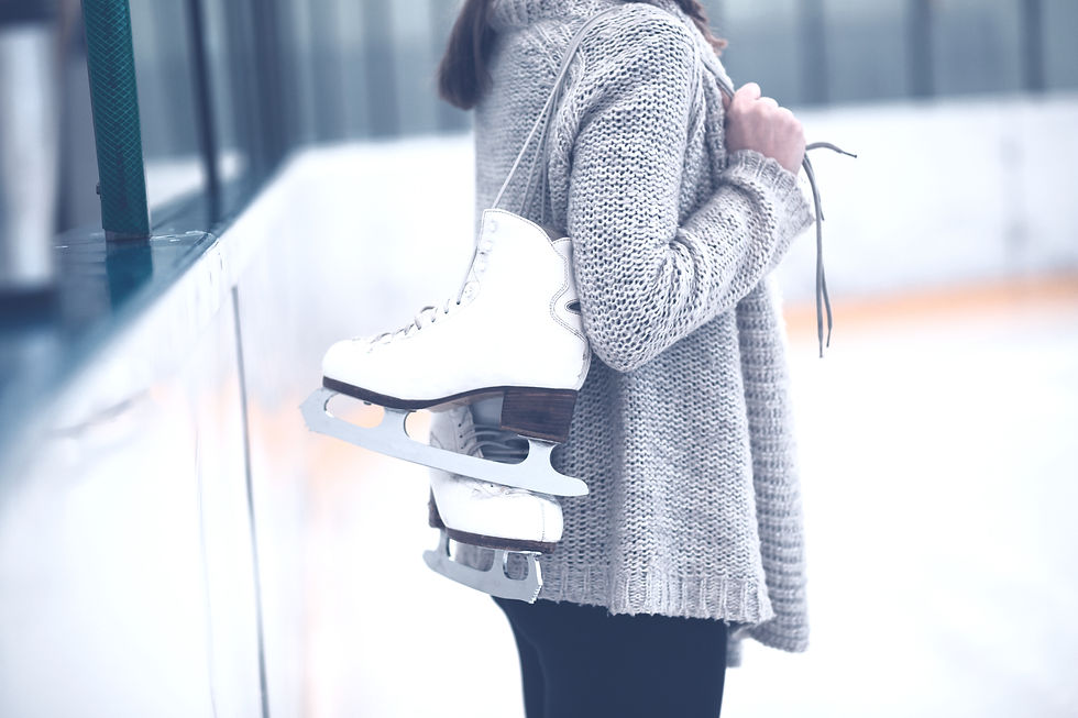 Woman at ice-skating rink holding skates._edited.jpg