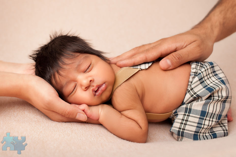 Mississauga Newborn Photography - Baby asleep on his side with parents gently holding him