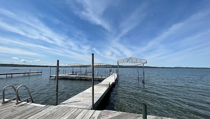 Renters dock with ladder stretching into blue Skaneateles Lake