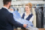 laundry-worker-girl-man-gives-customer-clean-clothes-dry-cleaners.jpg