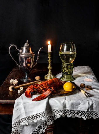 still life with lobster, candle, dice, pipe, lemon and Roemer 