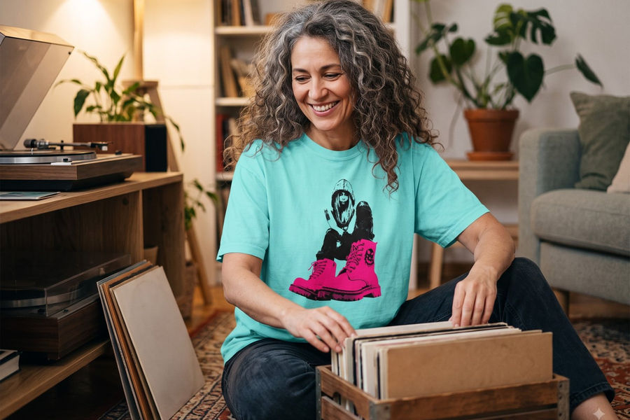 Woman flipping through vinyl records wearing the Pink Boots Girl tee