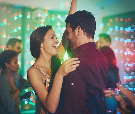 Couple, celebrate and dance in club at night on date with love in marriage or relationship