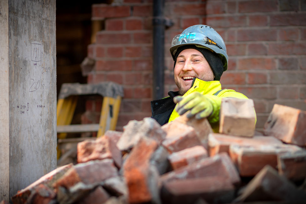 Residential groundworks contractor onsite doing hard work in London. 