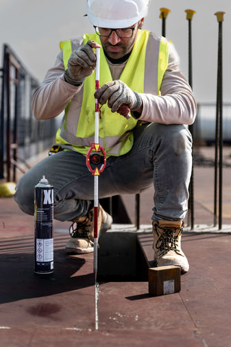 Engineer carefully checking height and position of concrete pour.