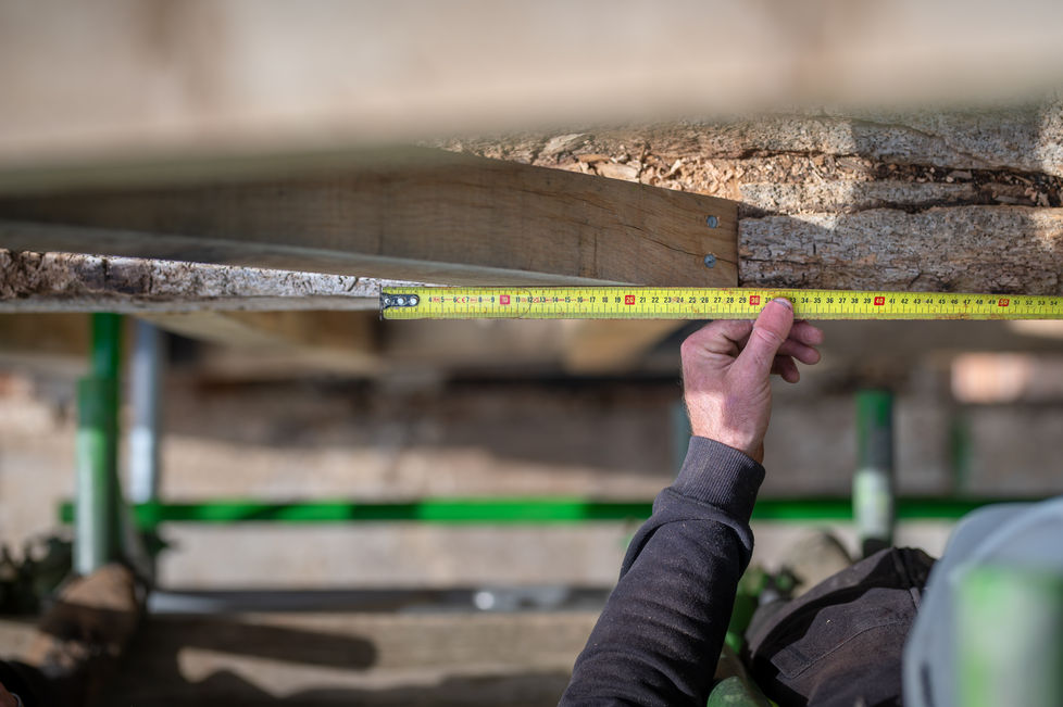 Timber frame restoration men working onsite restoring timber frame.