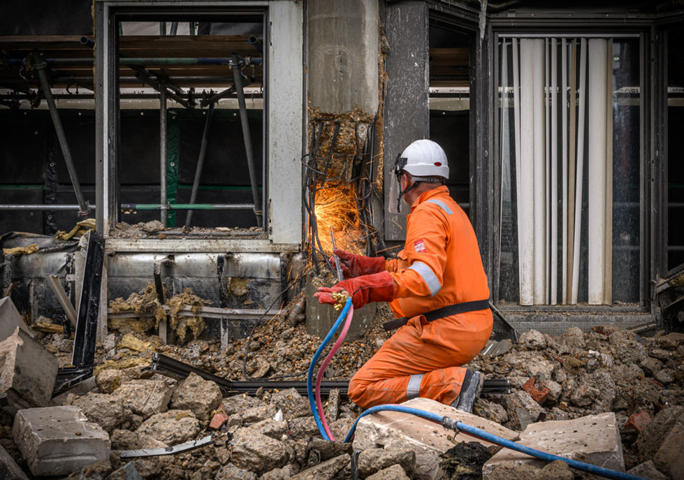 McGee engineer using oxyacetylene gas axe to cut rebar for demolition. 