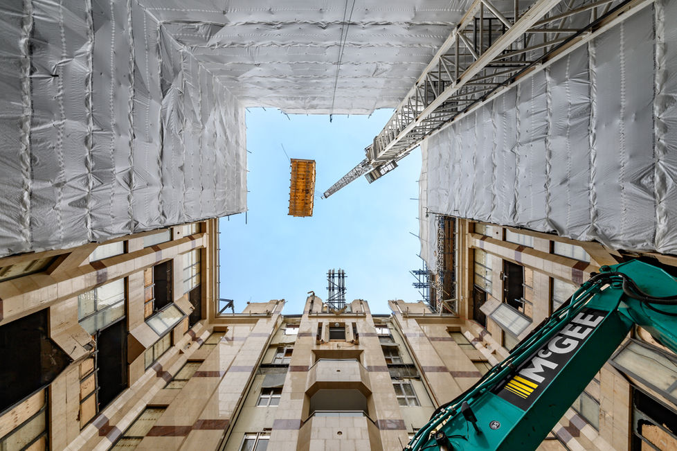 Looking up at skip being lowered for removal from site. 
