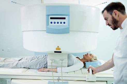 smiling-female-patient-having-abdomen-mri-scan-with-supervision-radiologist-hospital.jpg