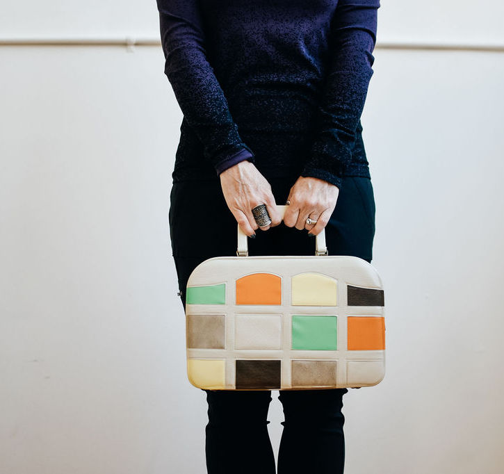 Kristina holds her briefcase.