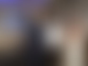 Three people holding a certificate in a meeting room