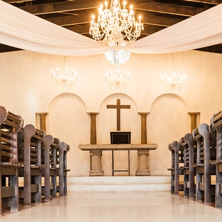 The Chapel at Avianto with its altar, chandeliers and wooden pews